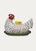 A large butter dish in the shape of a chicken.